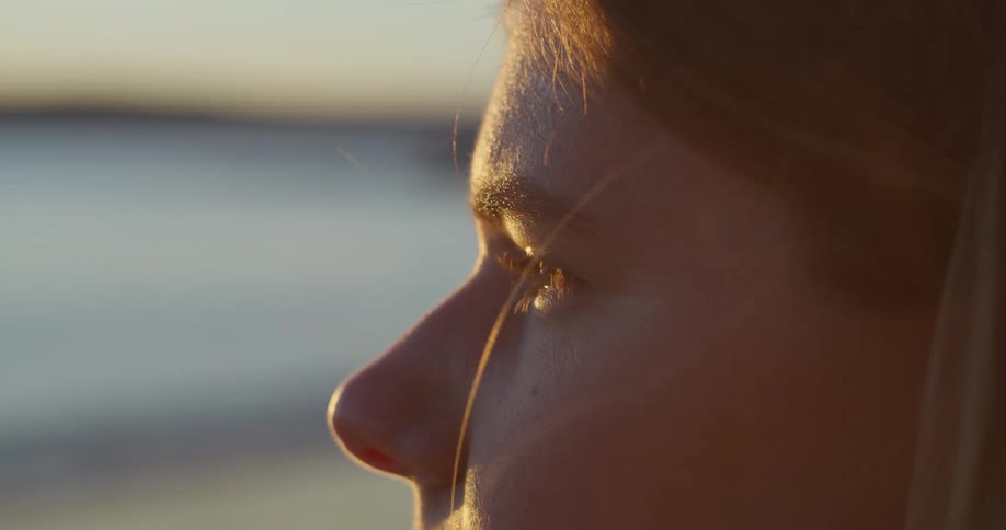A person is staring out over the water in the distance