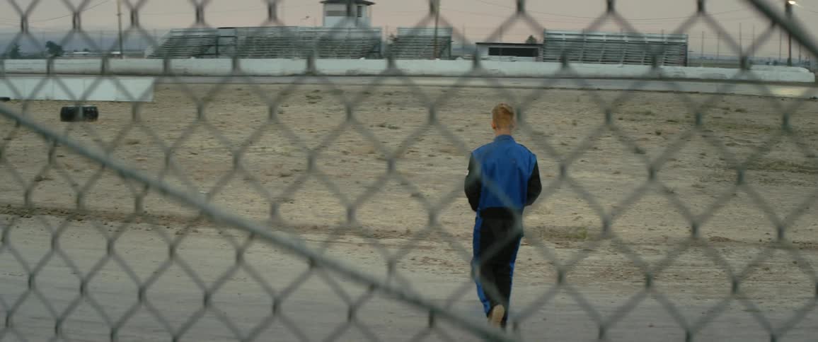 A man is walking outdoors in a rural area