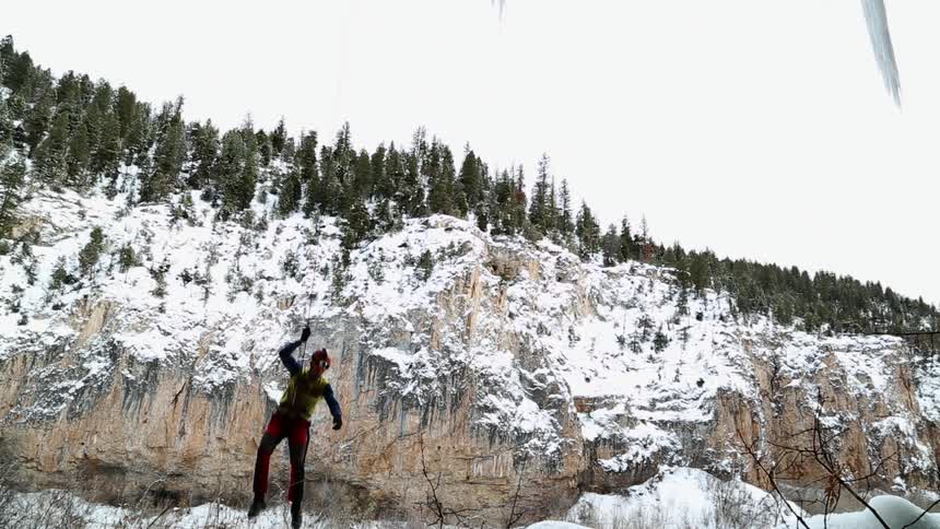 A man repels from a cliff using equipment