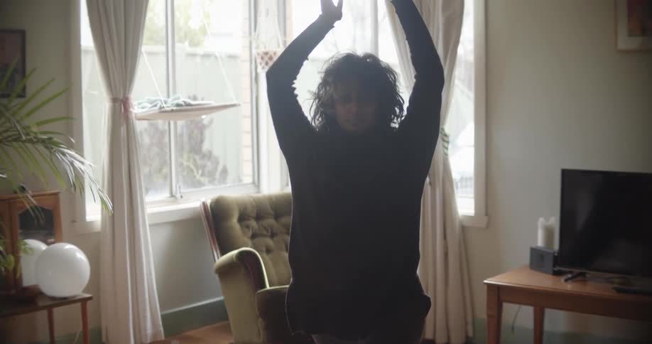 A woman is doing yoga poses in a room