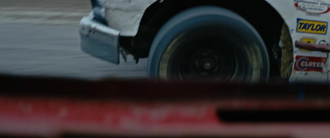 Race car driving on a race track at sunset