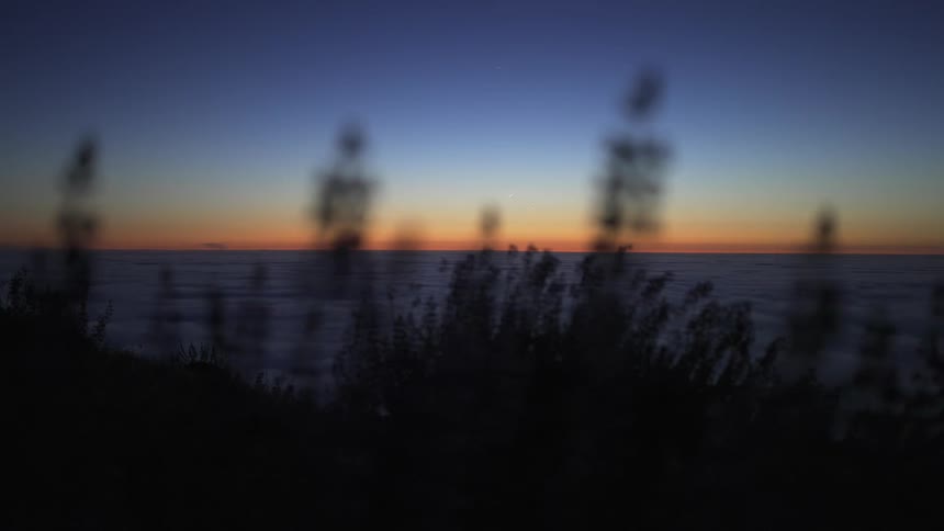 The sun is setting in the horizon