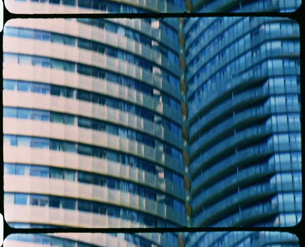 Tall skyscraper caught on vintage film at daytime
