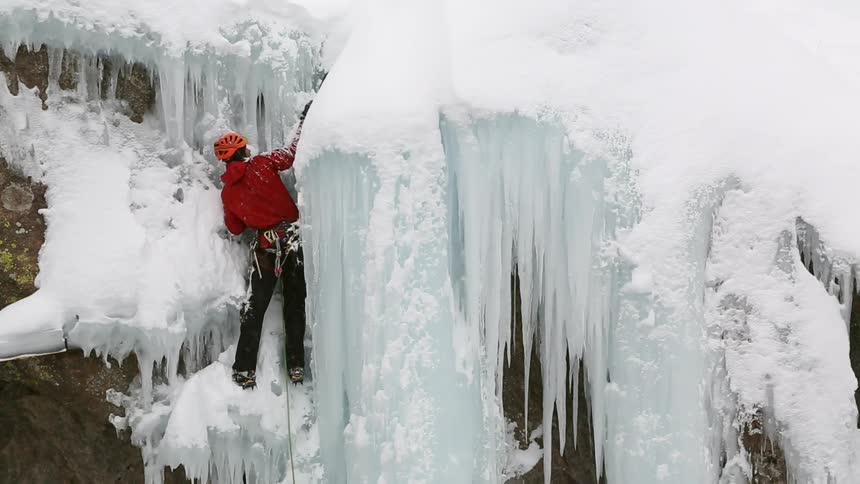 A man is ice climbing