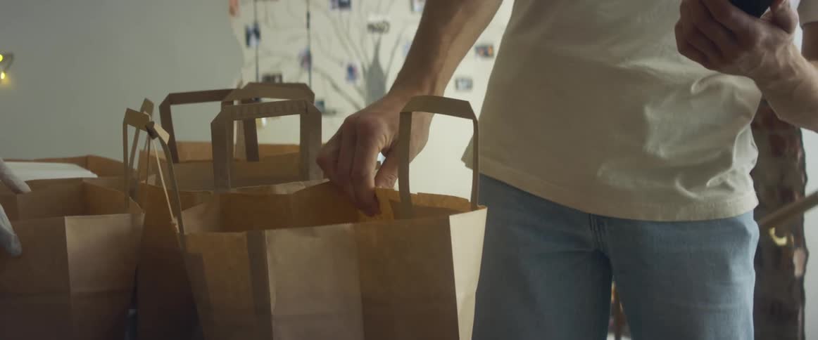 A food deliverer picks up an order from a restaurant