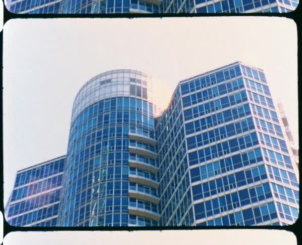 Footage of a tall building in a downtown city is displayed