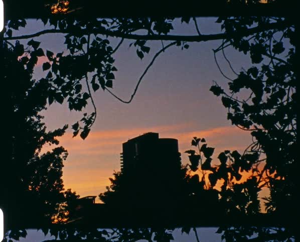 Film footage of a high rise apartment building as the sun sets