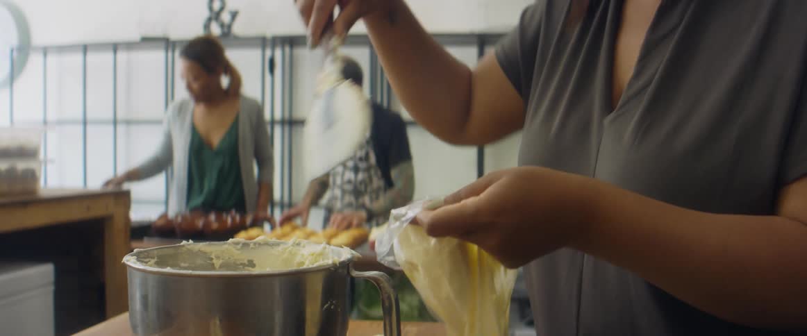 A group of people cooking together in a kitchen