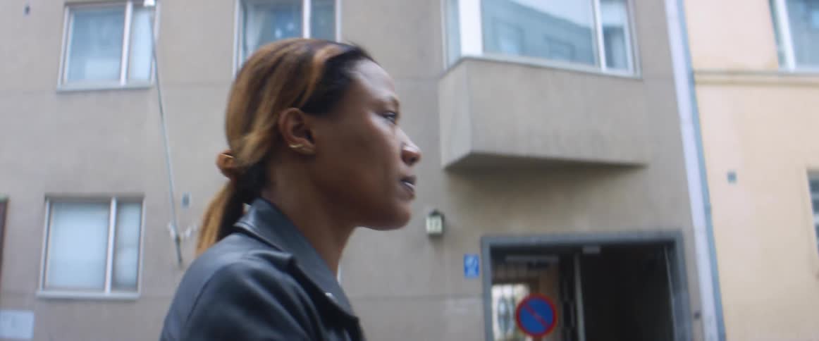 Young woman walking on the street of a city at daytime
