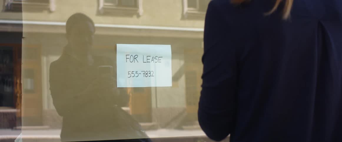 Woman looking at for lease