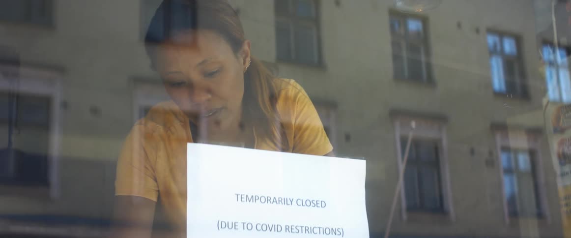 Woman putting up sign