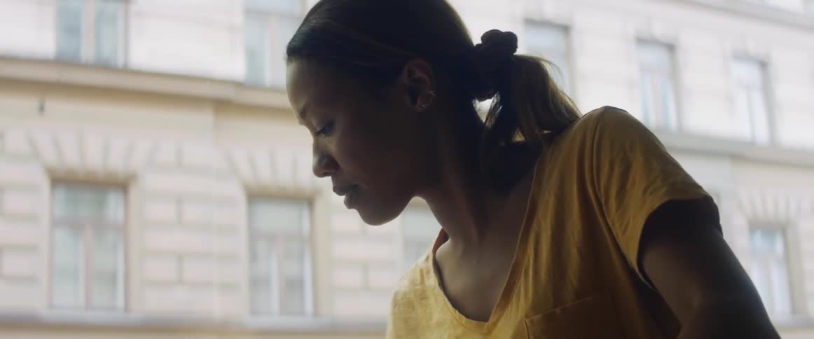 Woman completes task then looks at building before walking away