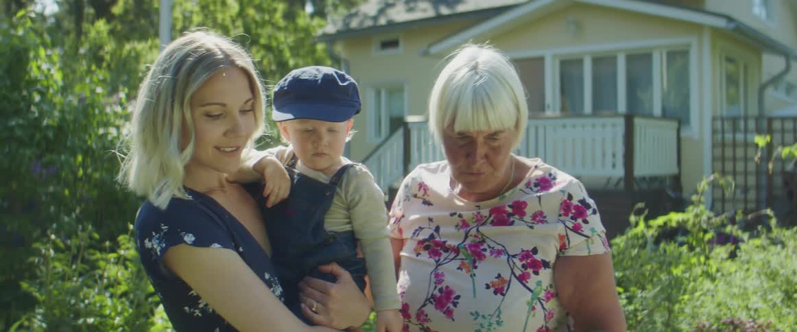 A mother daughter and grandmother standing outside