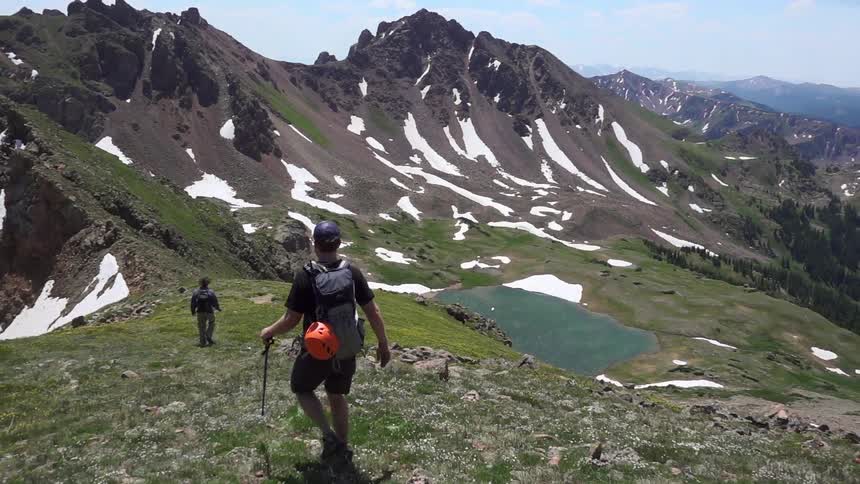 Two people are hiking on a mountain