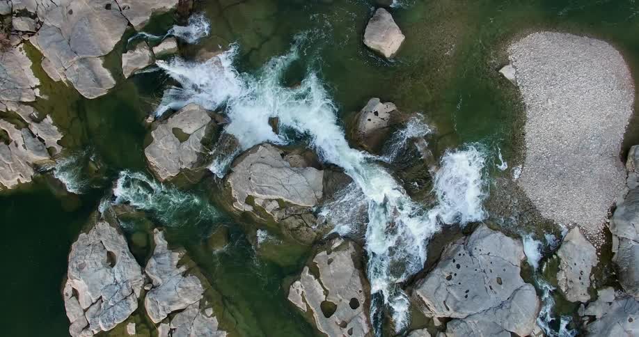 Aerial view of water in a stream moving over rocks