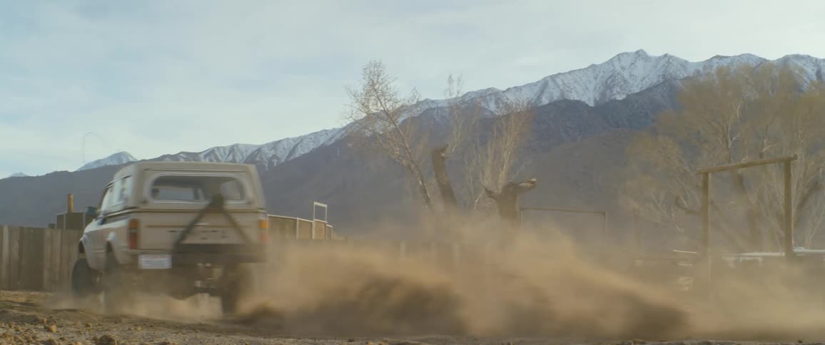 Truck drifting on the dirt on the backyard of a ranch in the mountains