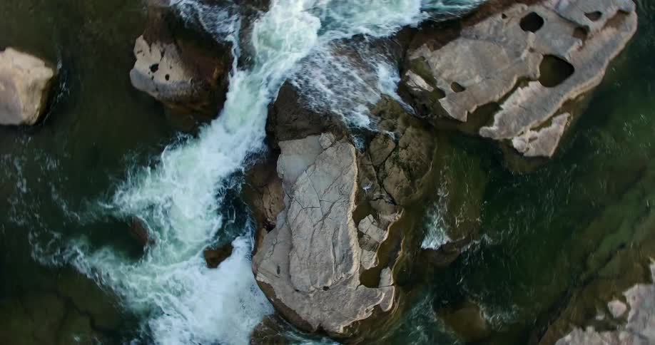 Fast moving water running through a rocky area seen in a spinning shot