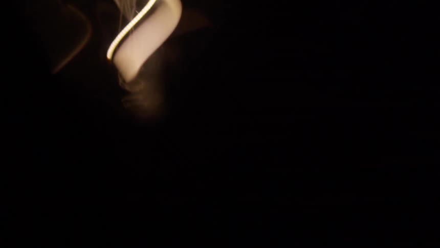 Yellow gray and black colors that look like a light bulb in a dark room