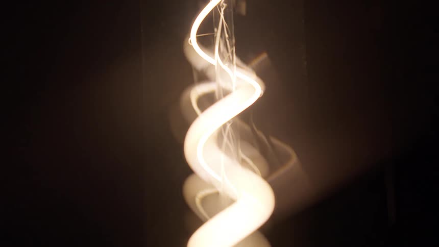 A closeup view of a chandelier turning on