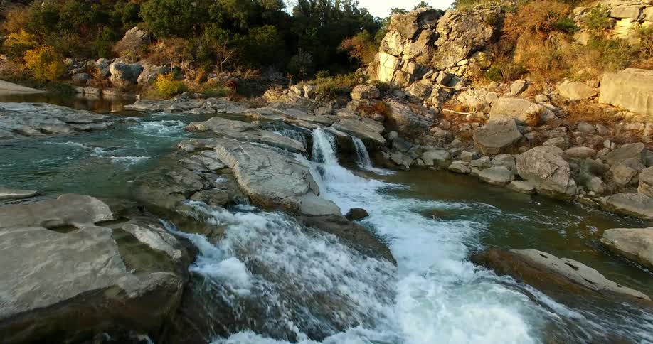 A rocky river near a forest