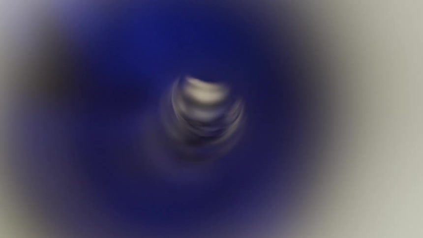 White blue and gray colors that look like light in a spinning straw