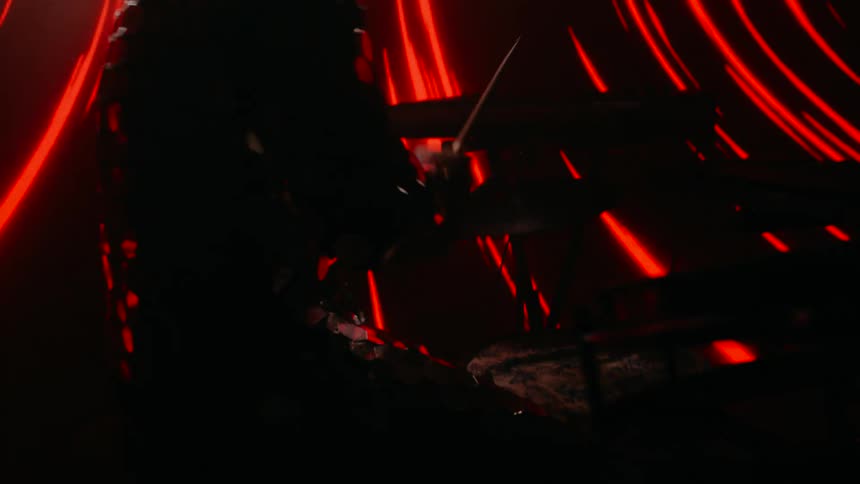 A man playing drums on a stage with a lot of lights