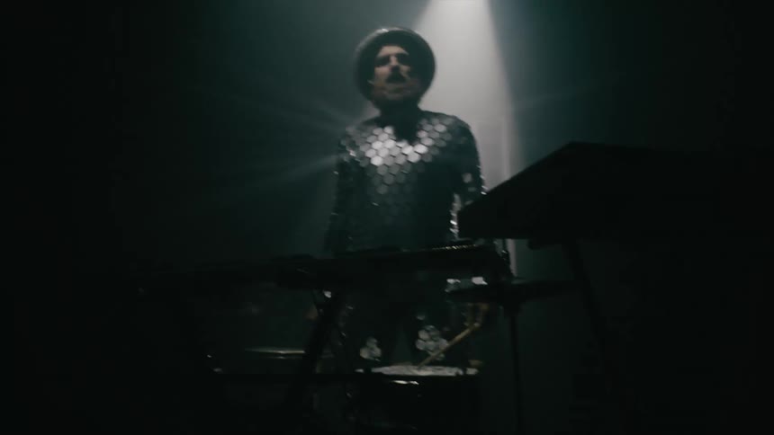 A man playing a keyboard on a stage