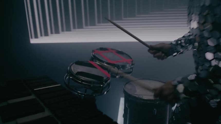 A man playing drums and keyboard on a stage