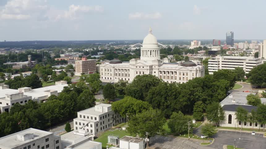 Dense trees and lush green lawns sit between government buildings
