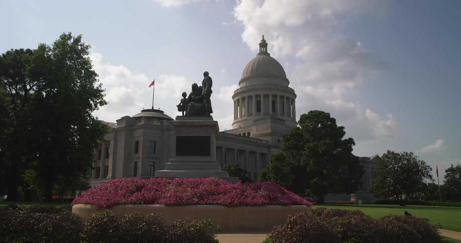 A view of a large building and statue outdoors