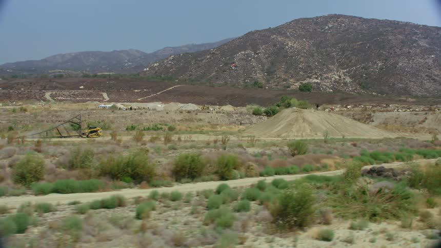 A man jumping a dirt bike over a large jump