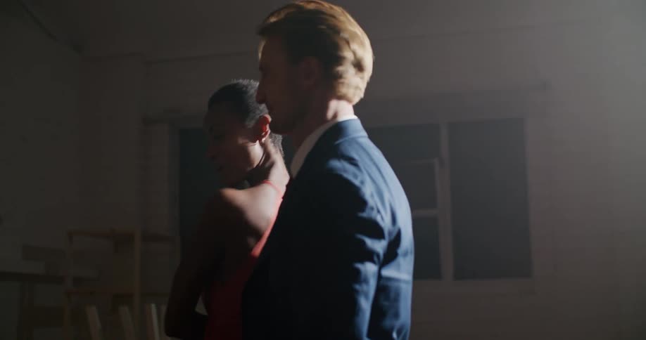 A man and woman dance under the spotlight