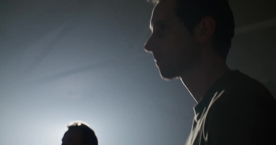Two men film video in a brightly light studio