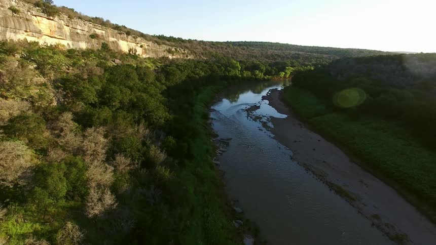 A river stretches along the bottom of a canyon