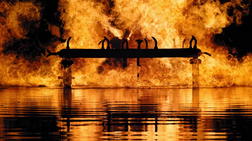 Flames rise in to the night sky as a fire rages outside