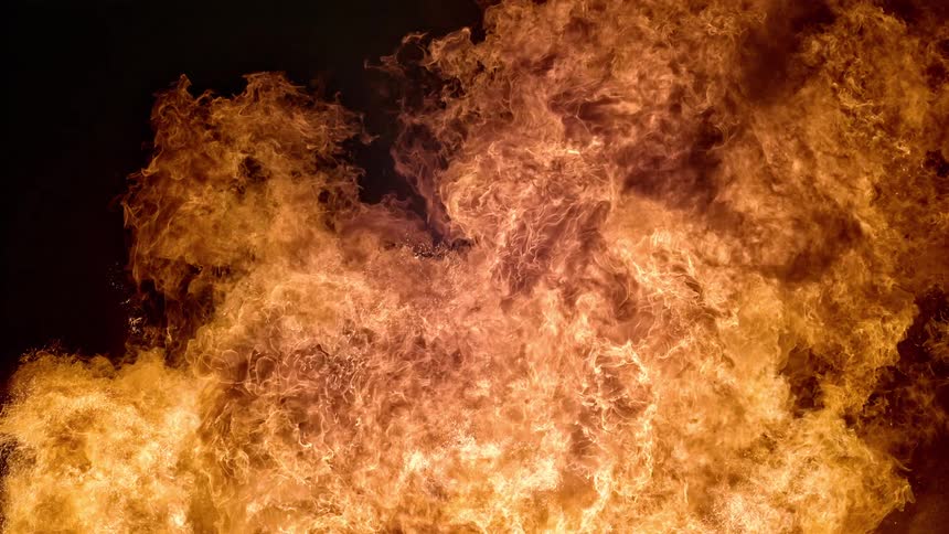 Flames fill the night sky as a fire roars