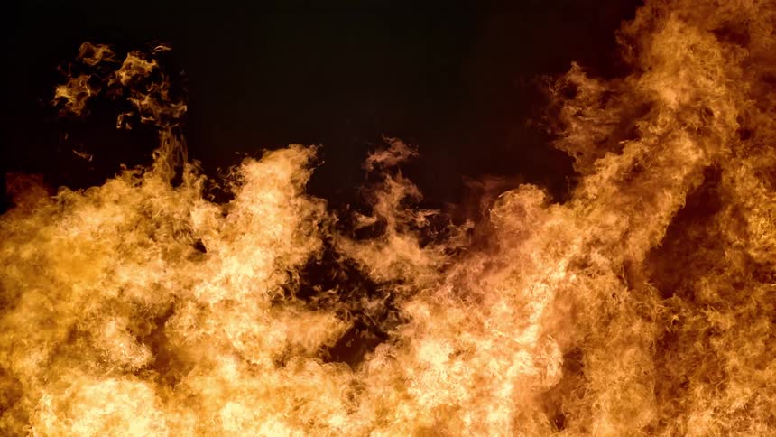 Orange flames and embers of a burning fire at night