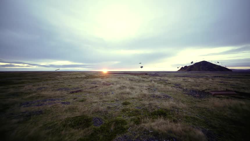 A landscape with grass with the sunset the sky and clouds in the background
