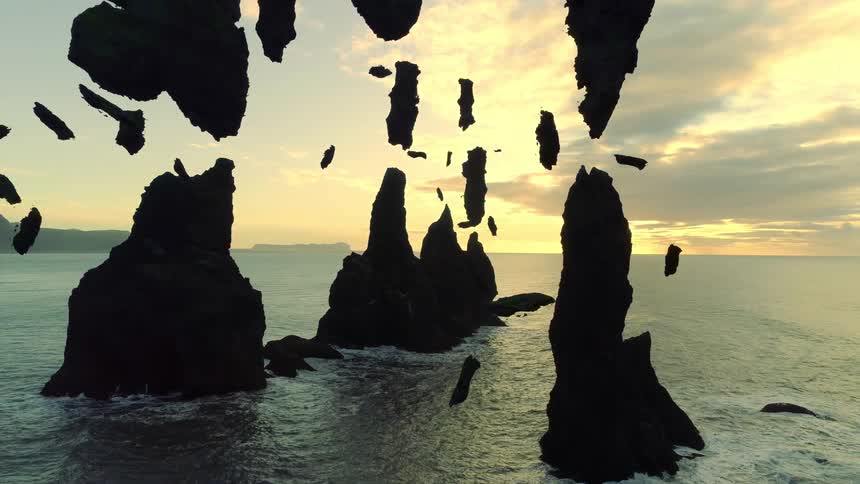 The rocks are shattered in the ocean with all the pieces floating around