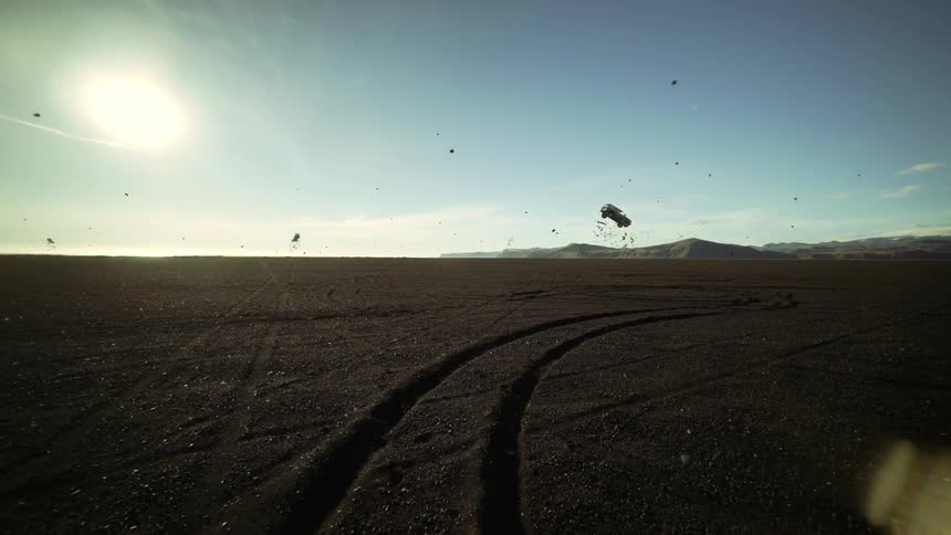 A landscape with debris with a mountain range the sky and clouds in the background