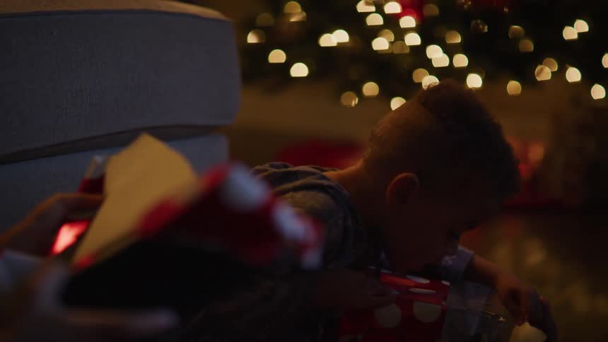 A brother and sister unwrapping presents