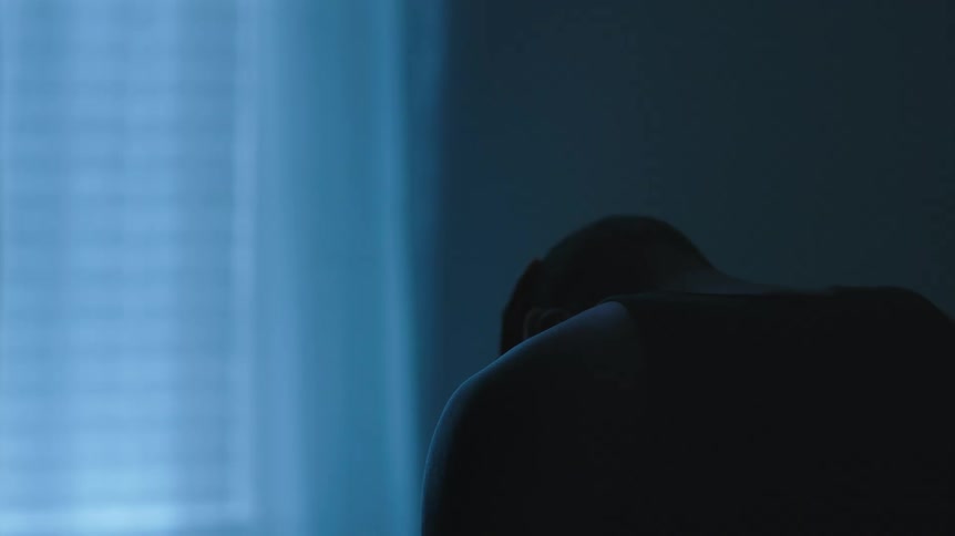 A man that is upset sitting in a room