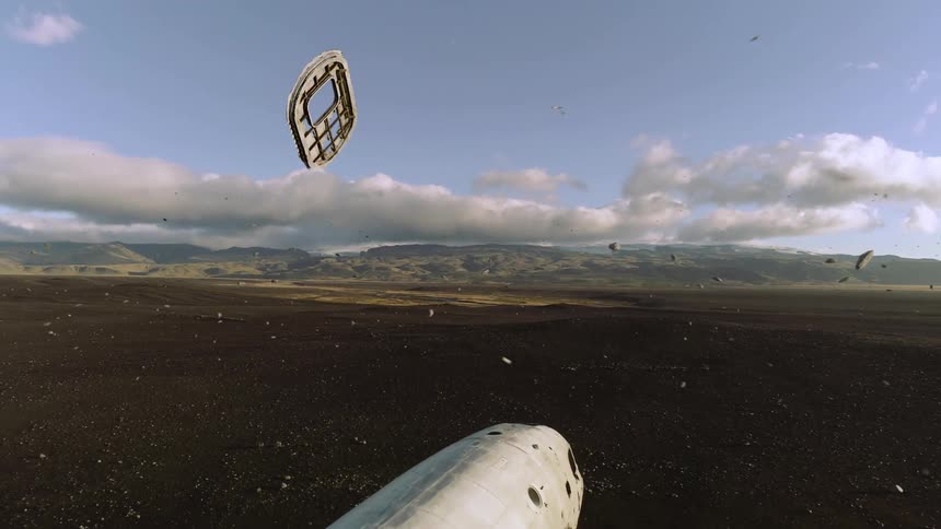 Mechanical parts float around the wreckage of an airplane in the a grassland during the day