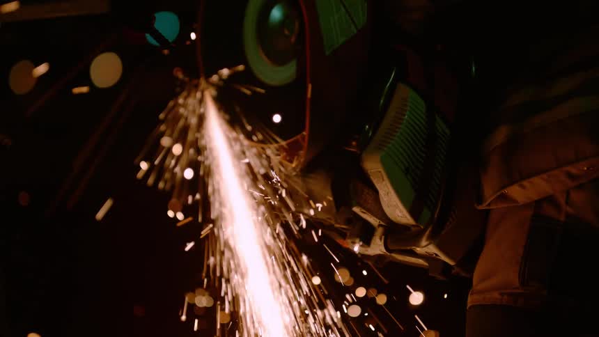 A close up of a grinder shooting sparks