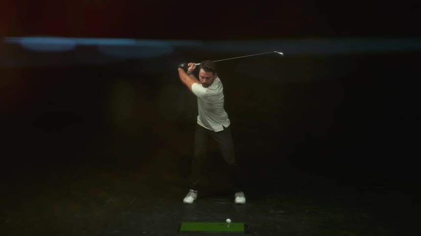 A slow mo of a man hitting a golf ball