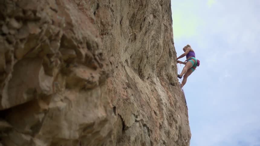 A woman is rock climbing