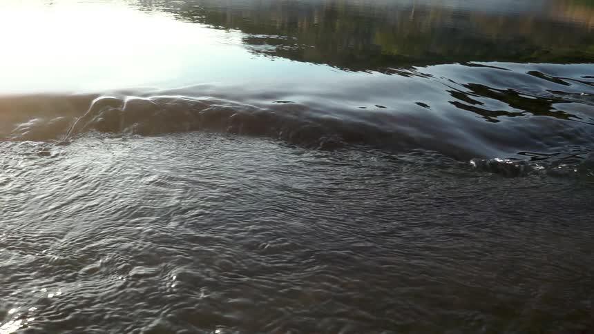 Close up of a stream with the sun reflecting