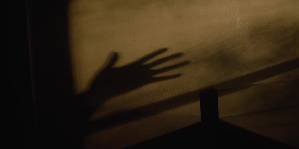 A view of a shadow of a hand on a wall