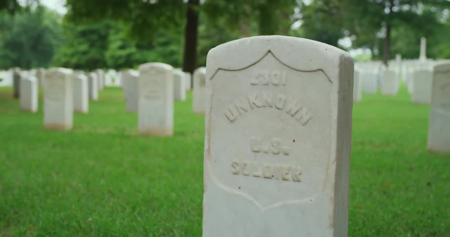 A tombstone for an unknown soldier in a cemetery during the day