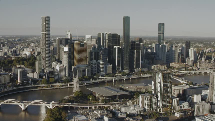 Tall skyscrapers fill both sides of a river running through downtown